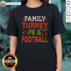 Happy family enjoying turkey pie and football, wearing matching 'Nice Family' ladies tees for a festive gathering.