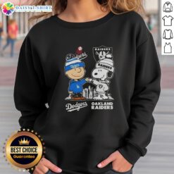 Alt Text: Hot Snoopy and Charlie Brown Los Angeles Dodgers x Las Vegas Raiders skyline sweatshirt design featuring iconic characters.