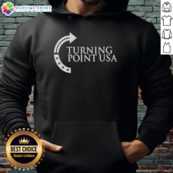 Sydney Sweeney wearing a Turning Point USA logo hoodie, showcasing a stylish and casual look in a vibrant setting.