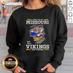 Official I May Live In Missouri But I'm A Minnesota Vikings Fan Forever sweatshirt featuring team colors and logo.