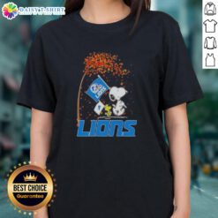 Pretty Snoopy and Woodstock celebrate the holidays on a Detroit Lions ladies tee, perfect for festive football fans.