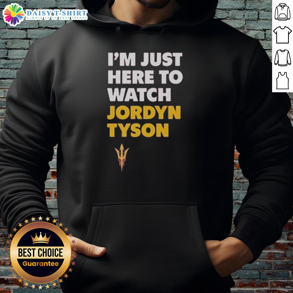 Alt Text: Jordyn Tyson wearing 'Im Just Here To Watch' hoodie, showcasing stylish streetwear for casual outfits.
