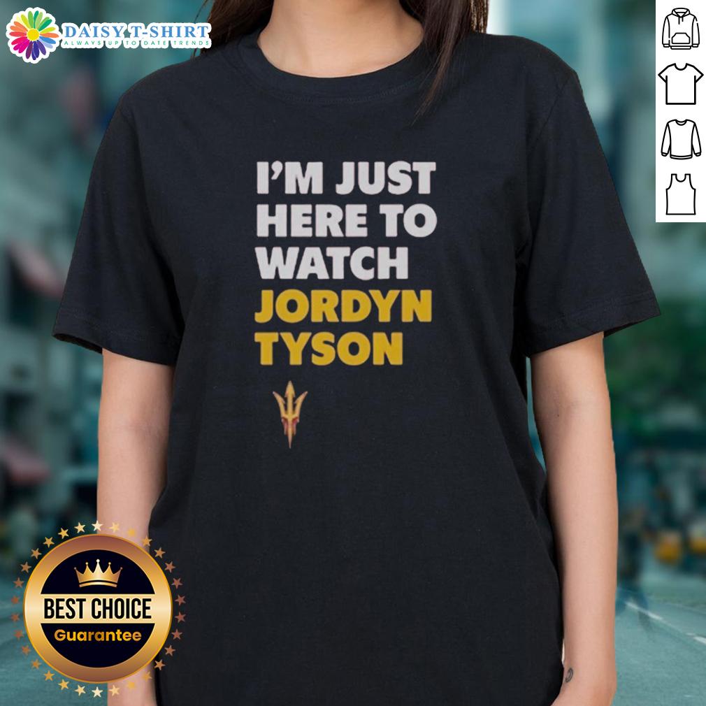 Alt Text: Top featuring Jordyn Tyson's 'Im Just Here To Watch' graphic design on a ladies tee, perfect for casual wear.