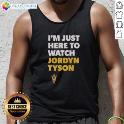 Alt Text: Jordyn Tyson wearing a stylish 'I'm Just Here to Watch' tank top, showcasing a trendy summer outfit.