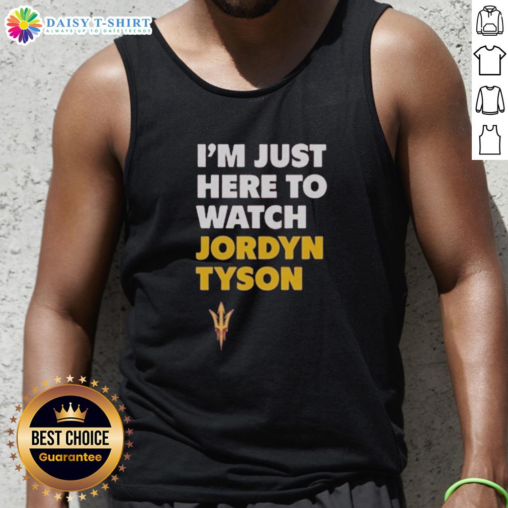 Alt Text: Jordyn Tyson wearing a stylish 'I'm Just Here to Watch' tank top, showcasing a trendy summer outfit.