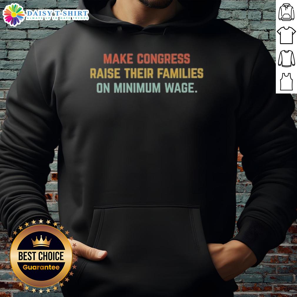 Person wearing a hoodie with 'Top Make Congress Raise Their Families on Minimum Wage' slogan, advocating for fair wages.