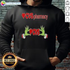 Awesome Grinch hands holding a CVS Pharmacy Christmas hoodie, perfect for holiday cheer and festive celebrations.