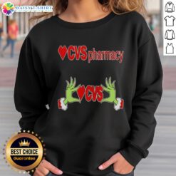 Awesome Grinch hands on a festive Christmas sweatshirt from CVS Pharmacy, perfect for holiday celebrations.