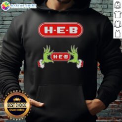 Awesome Grinch hands holding a heart on a cozy H-E-B Christmas hoodie, perfect for festive holiday cheer.