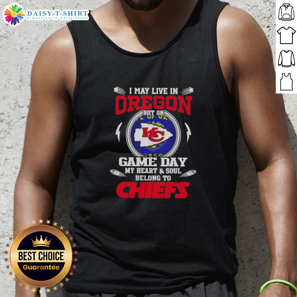 Cheerful fan wearing a Kansas City Chiefs tank top, showcasing pride while living in Oregon on game day.