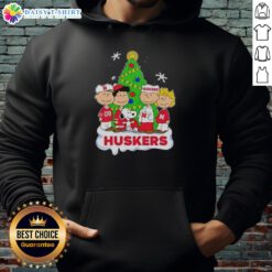 Awesome Peanuts characters Christmas hoodie featuring Nebraska Cornhuskers logo, perfect for festive fans.