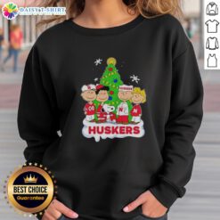 Alt Text: Awesome Peanuts characters Christmas sweatshirt featuring Nebraska Cornhuskers design, perfect for holiday cheer.