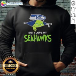 Alt Text: Adorable Grinch wearing a Seattle Seahawks football hoodie, showcasing team spirit and festive cheer.