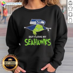 Adorable Grinch wearing a Seattle Seahawks sweatshirt, showcasing team spirit and holiday cheer.