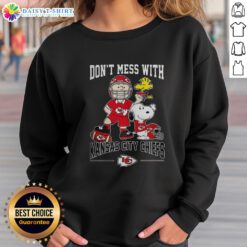 Alt Text: Cute Snoopy and Charlie Brown Peanuts sweatshirt featuring Don't Mess With Kansas City Chiefs football design.