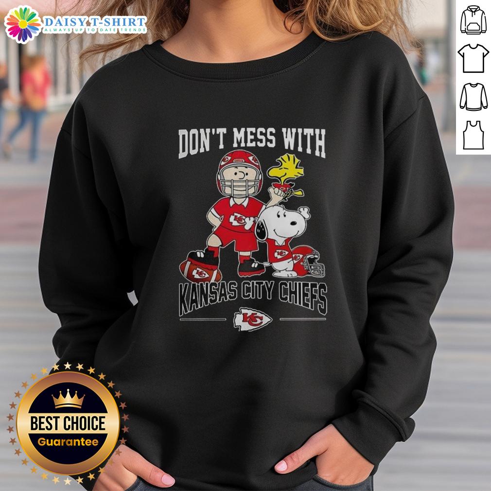 Alt Text: Cute Snoopy and Charlie Brown Peanuts sweatshirt featuring Don't Mess With Kansas City Chiefs football design.