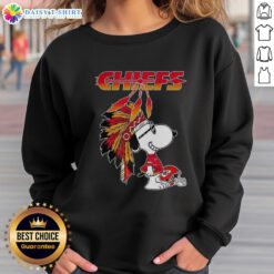 Alt Text: Cute Snoopy in war bonnets on Kansas City Chiefs football helmet sweatshirt, perfect for fans and cozy style lovers.