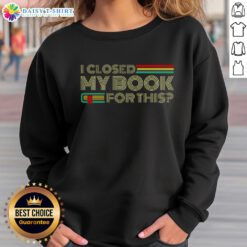 Cozy 'Good I Closed My Book For This' sweatshirt on a wooden table, perfect for book lovers and reading enthusiasts.