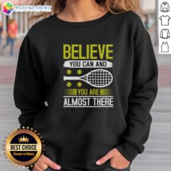 Motivational tennis sweatshirt featuring 'Believe You Can And You're Almost There' design for athletes.