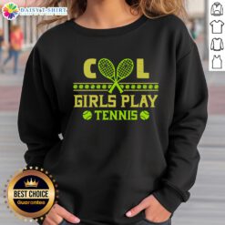 Nice cool girls in matching sweatshirts playing tennis on a sunny court, showcasing teamwork and fun.