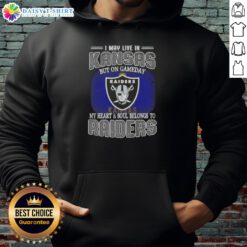 Fan wearing a Raiders hoodie, showcasing pride with the caption 'I May Live In Kansas, But My Heart Belongs To Raiders'.