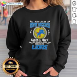 Alt Text: Cozy sweatshirt with I May Live In New Mexico, But My Heart Belongs To Detroit Lions design for game day fans.