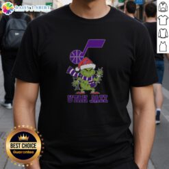 Alt Text: Utah Jazz Christmas Grinch Santa Hat Holiday 2025 T-Shirt featuring festive graphics and team colors for basketball fans.