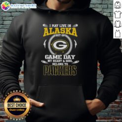 Green Bay Packers hoodie with 'I May Live In Alaska, But On Game Day, My Heart And Soul Belongs To' text design.