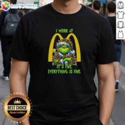 Alt Text: Premium Grinch Christmas Tree X McDonald's t-shirt design featuring I Work At It's Fine Everything Is Fine slogan.