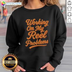 Person wearing an Awesome Working On My Reel Problems Fishing Sweatshirt while fishing on a sunny day, showcasing fishing style.