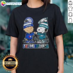 Alt Text: Cute Charlie Brown fist bump with Snoopy, featuring Philadelphia skyline and 76ers, Eagles sports theme on ladies tee.