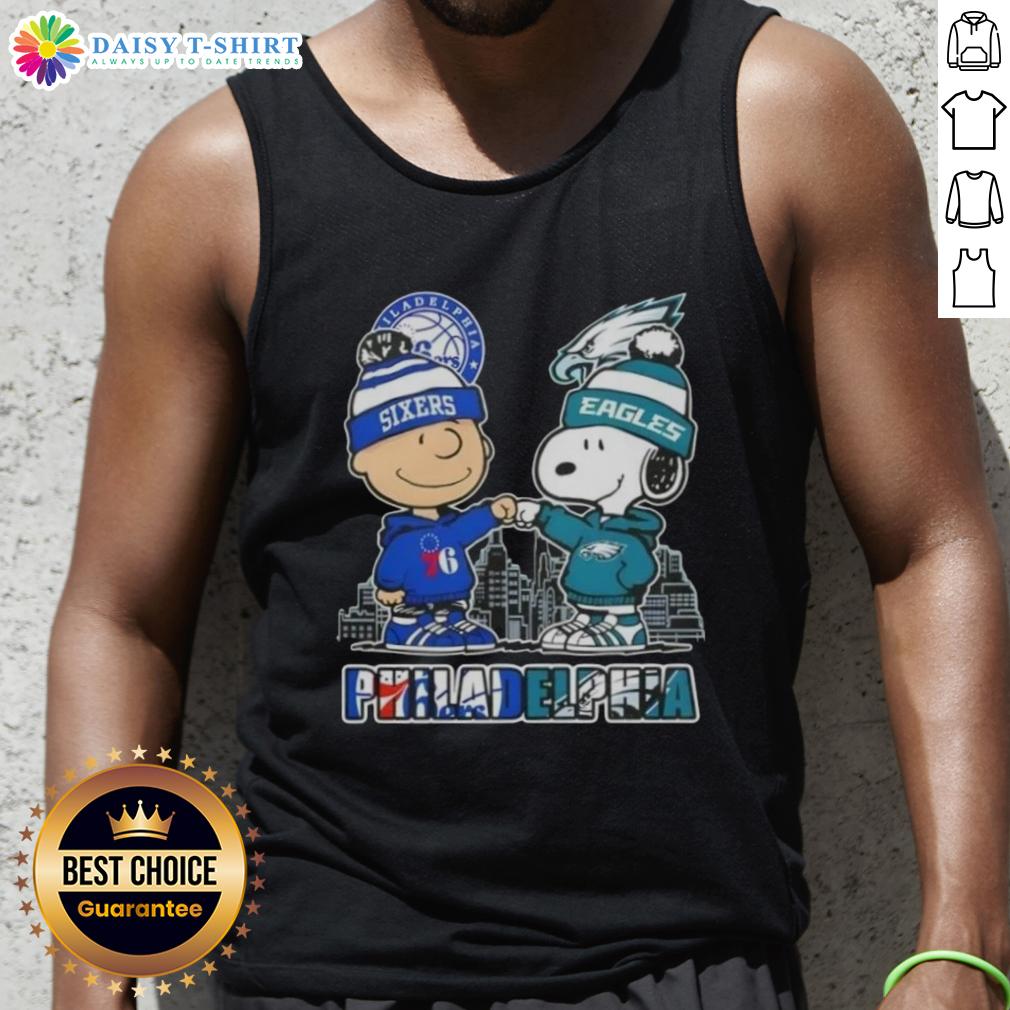 Alt Text: Cute Charlie Brown fist bump with Snoopy, Philadelphia skyline tank top featuring 76ers and Eagles logos.