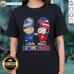 Cute Charlie Brown fist bump with Snoopy, featuring Philadelphia City Sports 76ers x Phillies ladies tee design.