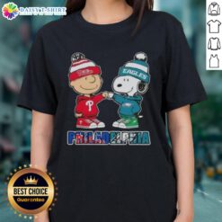 Adorable Charlie Brown and Snoopy fist bump on a Philadelphia sports tee, celebrating Phillies and Eagles pride.