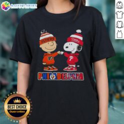 Cute Charlie Brown fist bump with Snoopy, perfect for Philadelphia sports fans. Phillies and Flyers ladies tee design.