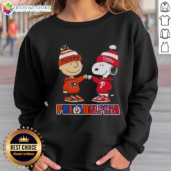 Cute Charlie Brown and Snoopy fist bump in Philadelphia sports sweatshirt featuring Phillies and Flyers logos.