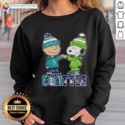 Cute Charlie Brown and Snoopy fist bump in Seattle sports sweatshirt featuring Mariners and Seahawks logos.