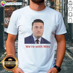 Happy Wes Streeting wearing 'We're With Wes' T-shirt, showcasing support for the politician in a vibrant, engaging setting.