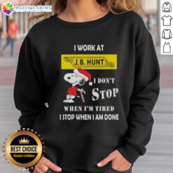 Christmas sweatshirt featuring Snoopy with 'I work at J.B. Hunt, I don't stop when I'm tired, I stop when I'm done' quote.