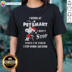 Alt Text: Cute Snoopy graphic on a Christmas ladies tee, featuring 'I work at PetSmart, I don't stop when I'm tired, I stop when I'm done.'