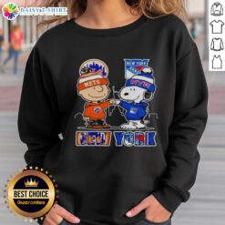 Official New York Mets and New York Rangers Snoopy sweatshirt featuring vibrant team colors and playful design.