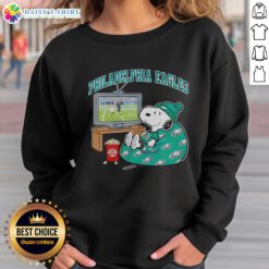 Official Philadelphia Eagles Snoopy cozy game day sweatshirt in Peanuts style, perfect for football fans.