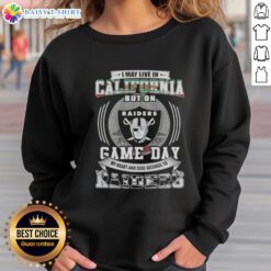 Alt Text: Fan wearing 'Good I May Live In California But My Heart Belongs To Las Vegas Raiders' sweatshirt on game day.