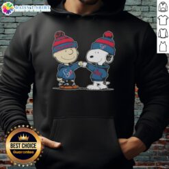 Charlie Brown and Snoopy fist bump in Houston Texans football hoodie, showcasing fun Good Peanuts collaboration.