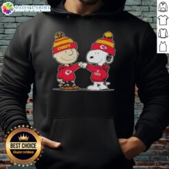 Alt Text: Charlie Brown and Snoopy fist bump in a Kansas City Chiefs hoodie, celebrating with good vibes and football spirit.