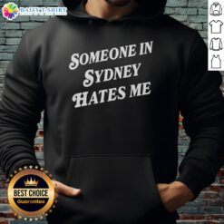 Alt Text: Cozy 'Good Someone In Sydney Hates Me' hoodie displayed against a vibrant urban backdrop, perfect for casual wear.