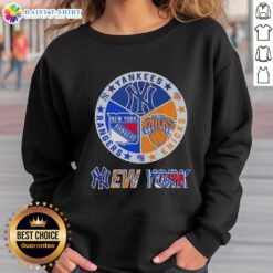 Alt Text: Happy New York City Sports Yankees Knicks Rangers logos combine sweatshirt showcasing iconic team designs.