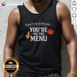 Stylish tank top featuring 'Nice If You're Not At The Table, You're On The Menu' slogan for bold statement fashion.