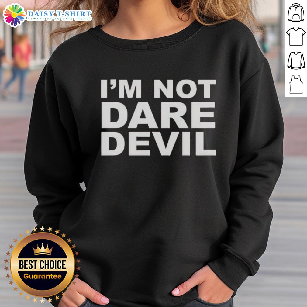 Jon Bernthal wearing 'I'm Not Dare Devil' sweatshirt, showcasing a casual style and confident demeanor in a vibrant setting.