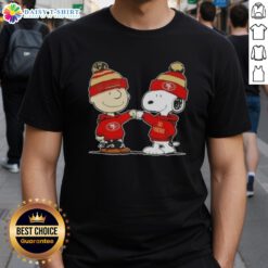 Top Peanuts Charlie Brown fist bump with Snoopy on a San Francisco 49ers football T-shirt, perfect for fans.